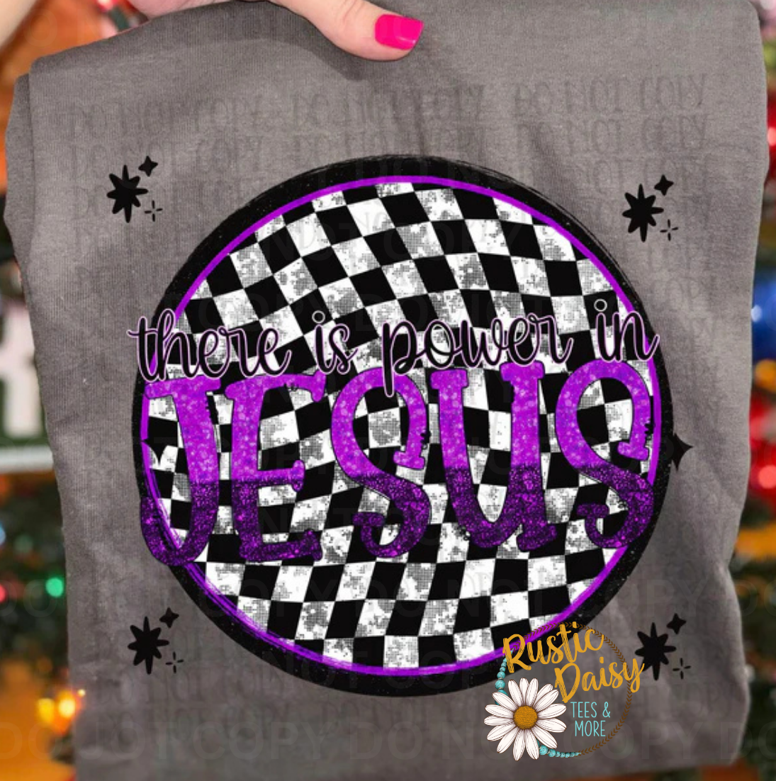 T-shirt with there is power in JESUS text in purple letters on black and white checkered circle with stars