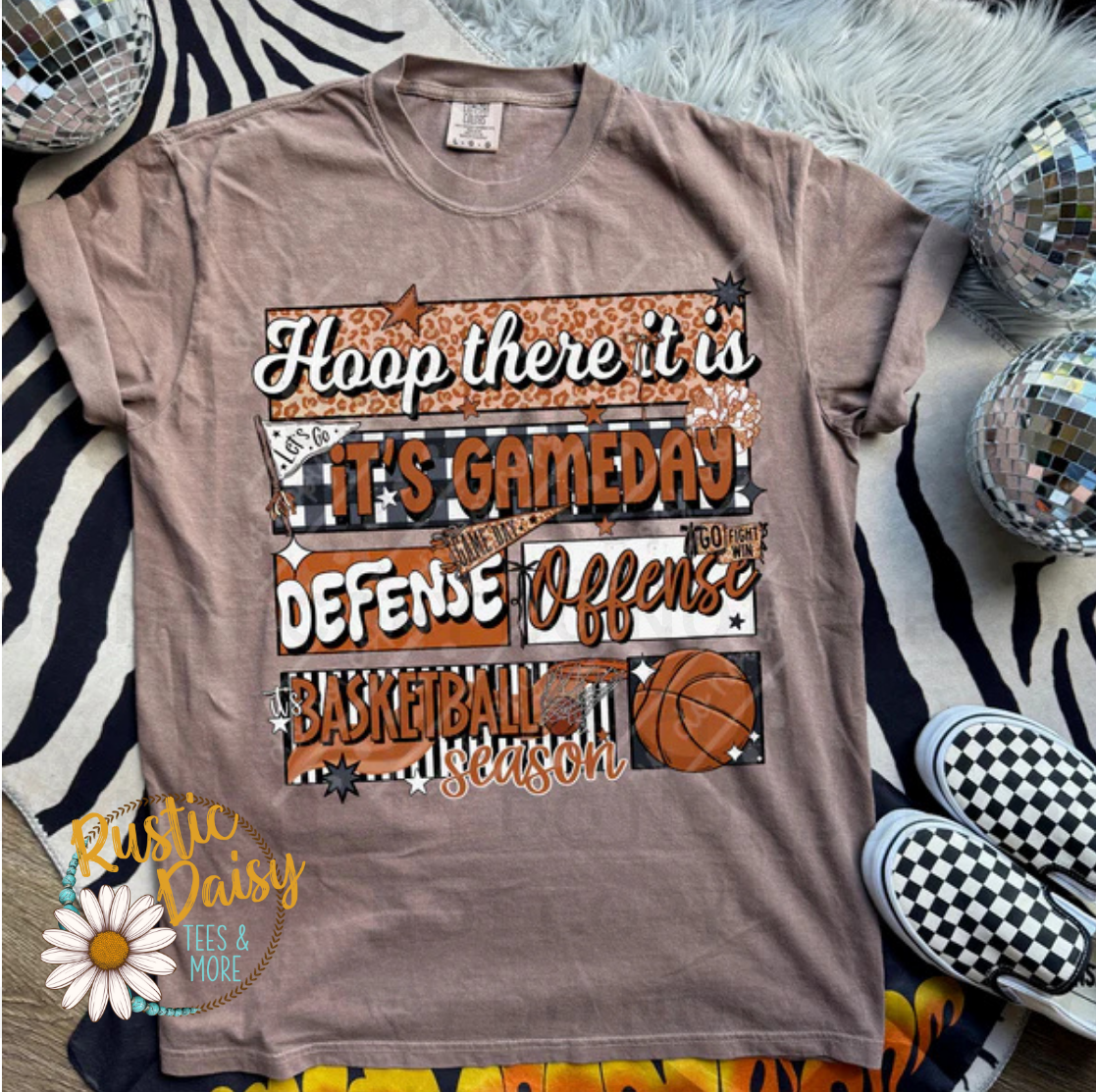 T-shirt with basketball quotes collage including phrases like How We Do It, All Day, Defense, and Hustle in patterned letters with basketball graphics