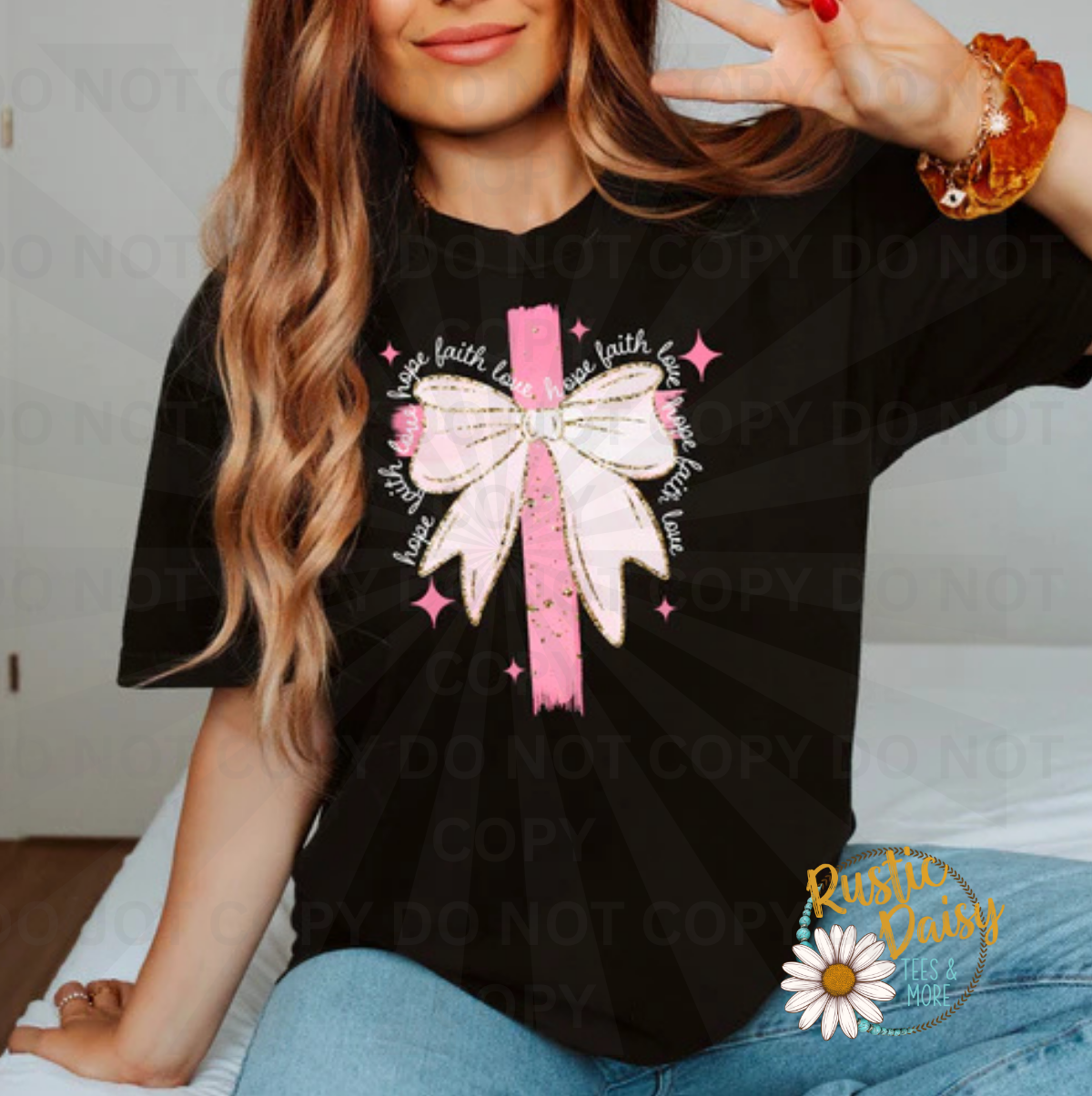 Pink cross with white bow and Hope Faith Love text circling the design