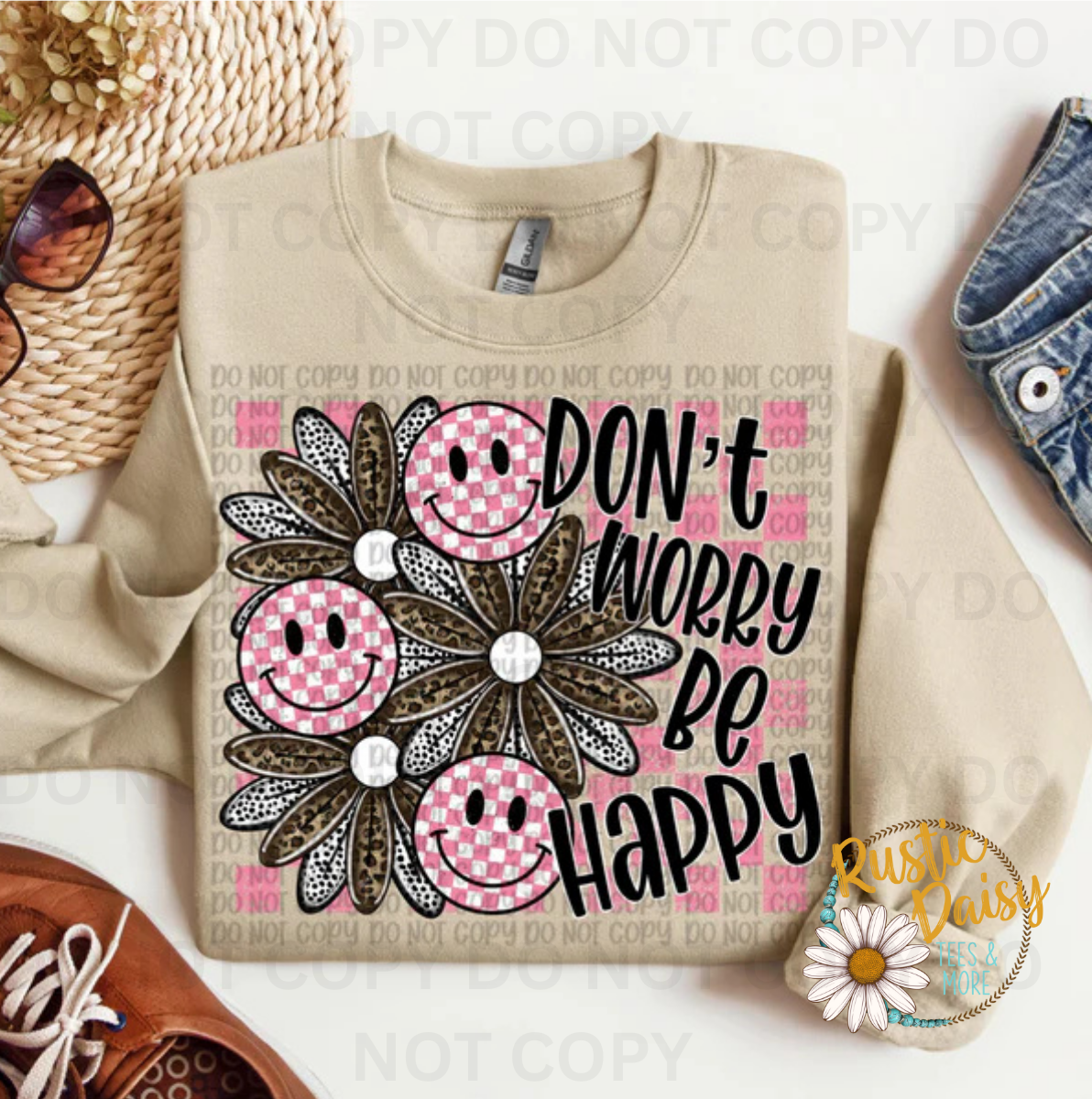 T-shirt with Don't Worry Be Happy text, pink smiley faces, and daisy flowers