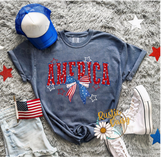 AMERICA block lettering with flag bow and stars