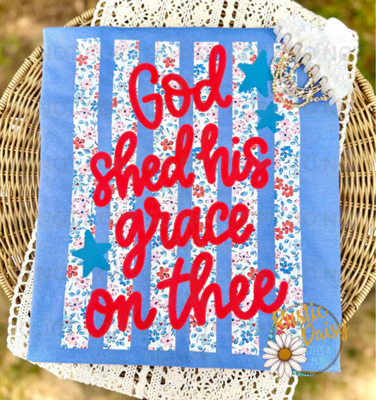 "God Shed His Grace on Thee" in red script over floral stripes with blue stars