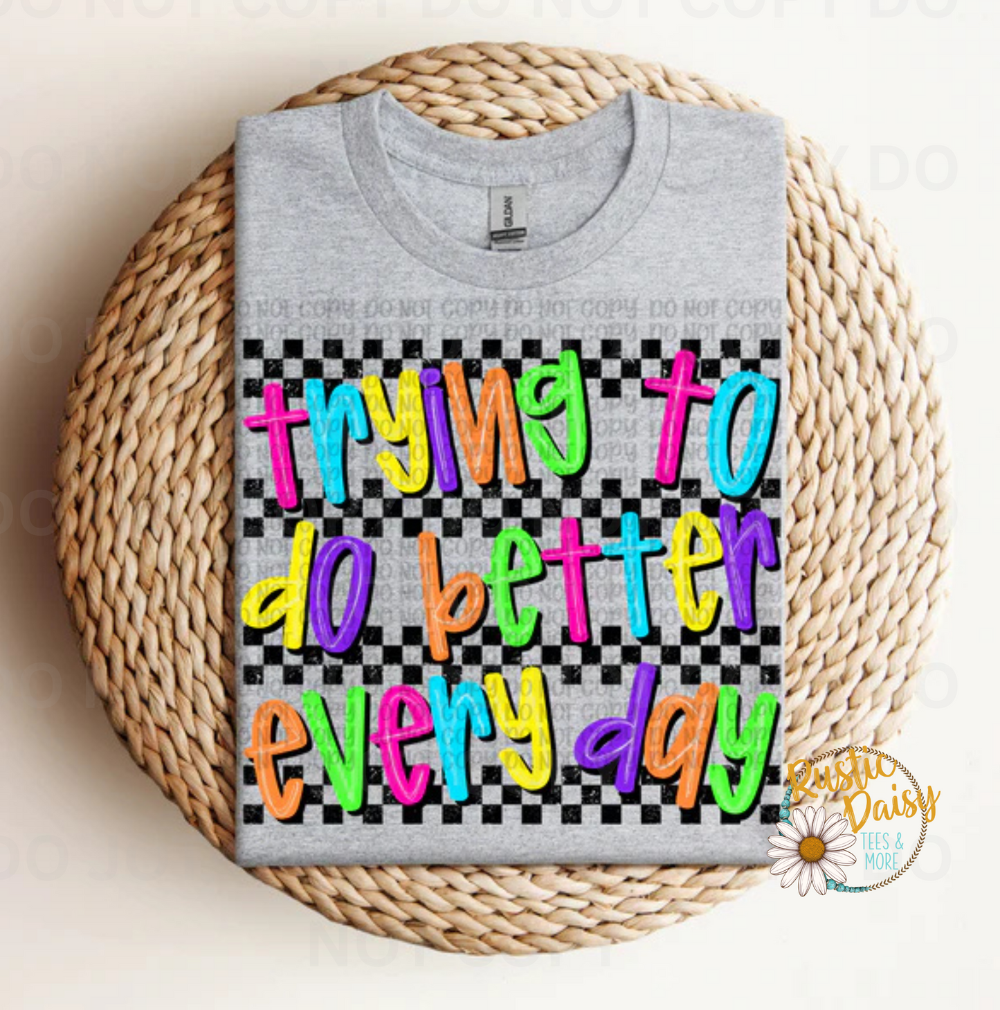 T-shirt with trying to do better everyday text in colorful letters on black and white checkered background