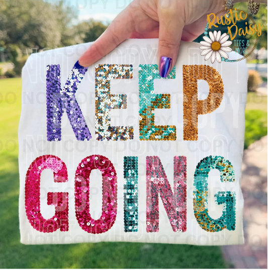T-shirt with KEEP GOING text in colorful sequin-style letters - purple, silver, turquoise, and gold
