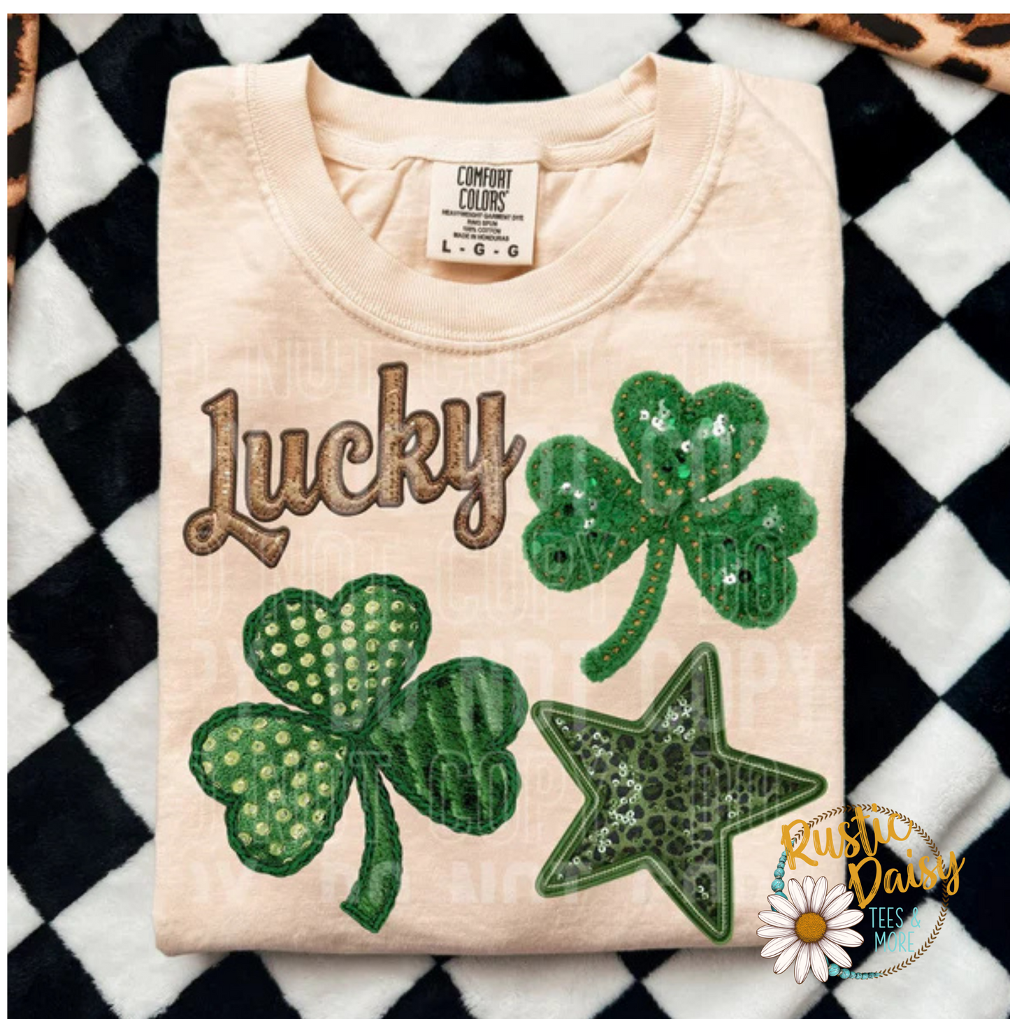 T-shirt with Faux sequin Lucky text in script lettering with multiple faux sequin 
shamrocks in different patterns and green star