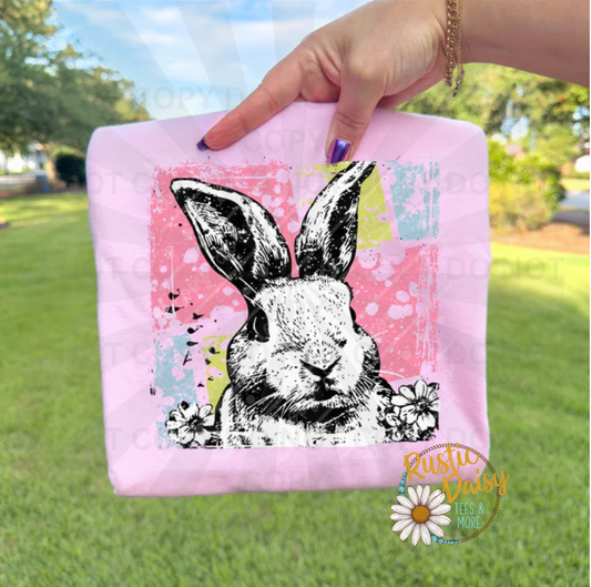 Black and white sketched bunny with daisies and pink, lime green and turquoise patch background