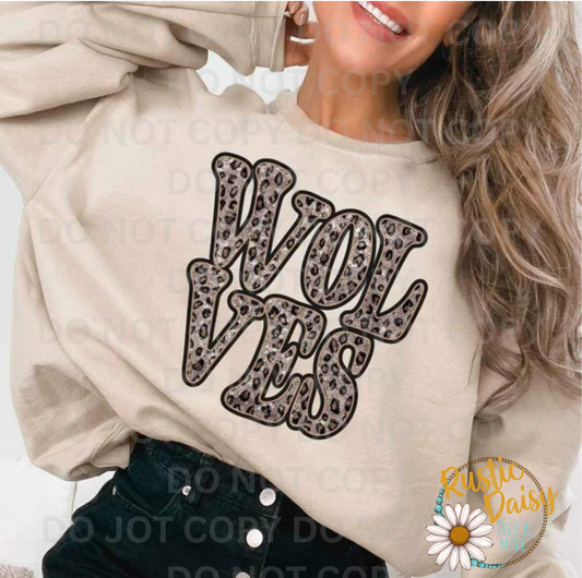 T-shirt with WOLVES text in retro wavy letters filled with leopard print pattern