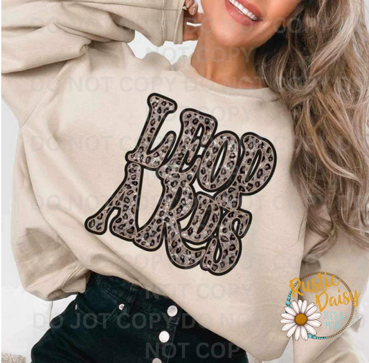 T-shirt with LEOPARDS text in retro wavy letters filled with leopard print pattern