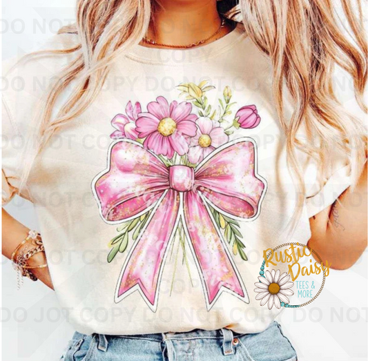 Pink ribbon bow surrounded by colorful floral accents