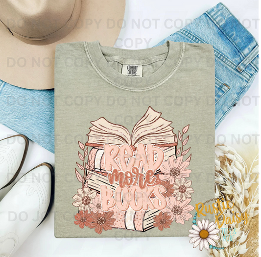 Stacked open books with Read More Books script and pink floral accents