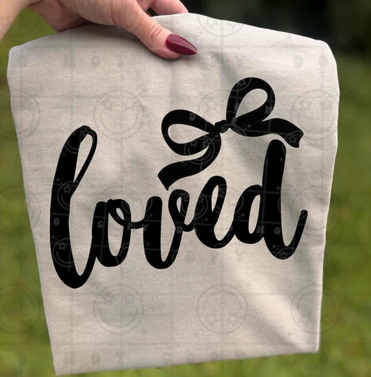 Loved text in decorative font with black ribbon bow accent